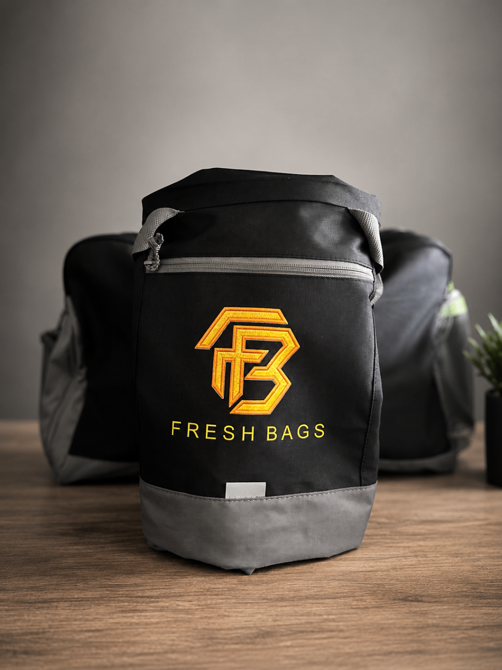 Fresh Bag premium black gym bag with gold FB emblem, front view